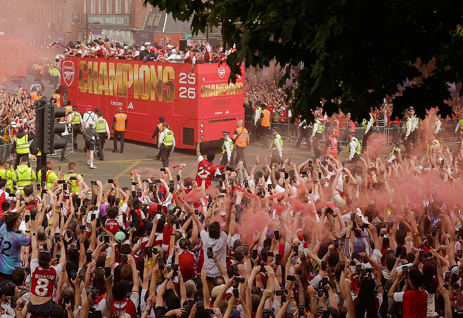 Arsenal supporters celebrating a title victory parade in north London