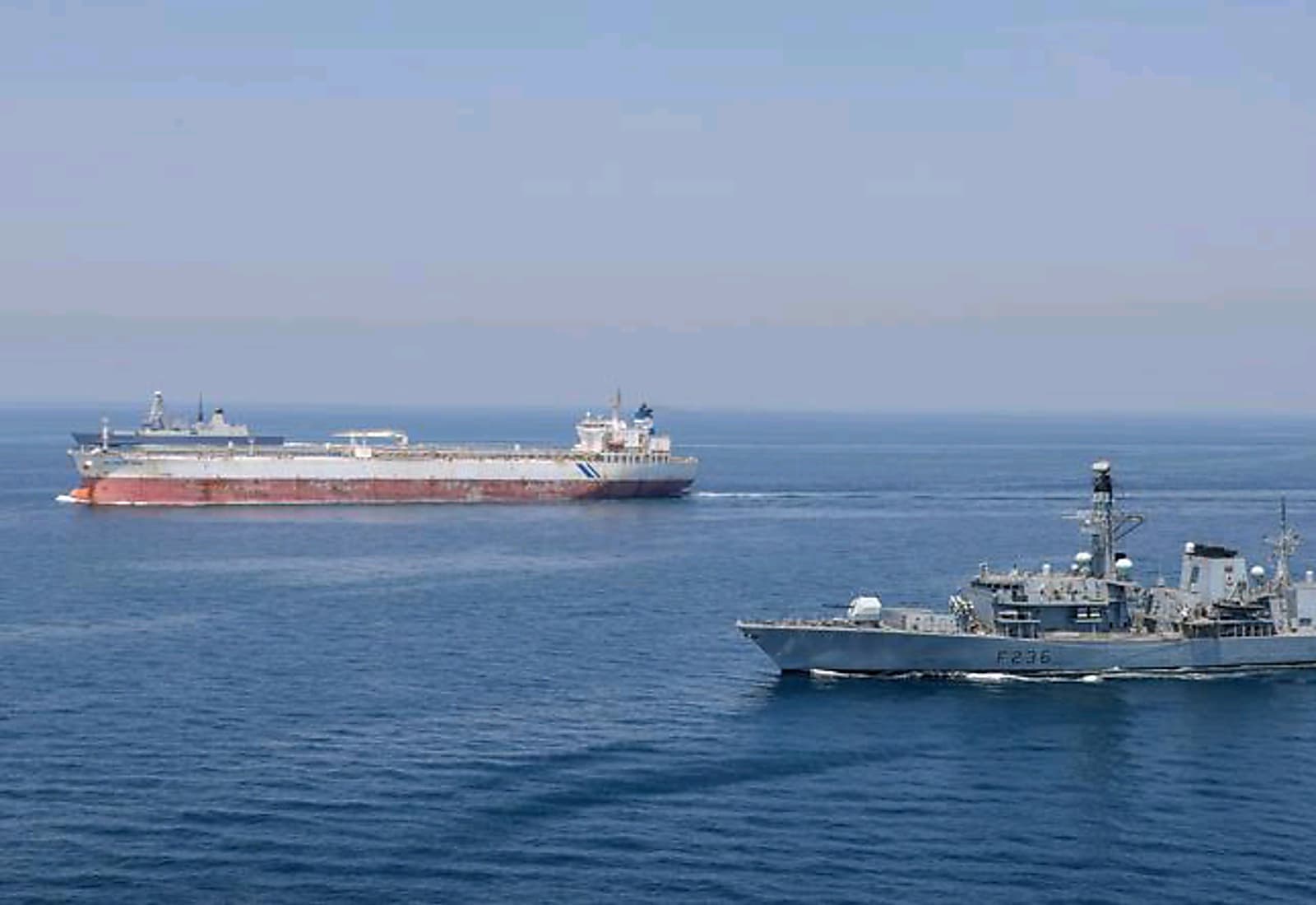 US warship and Iranian missile launch in the Strait of Hormuz
